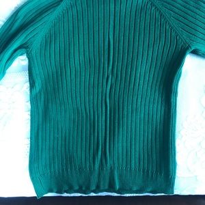 Emerald green sweater with silver zipper.